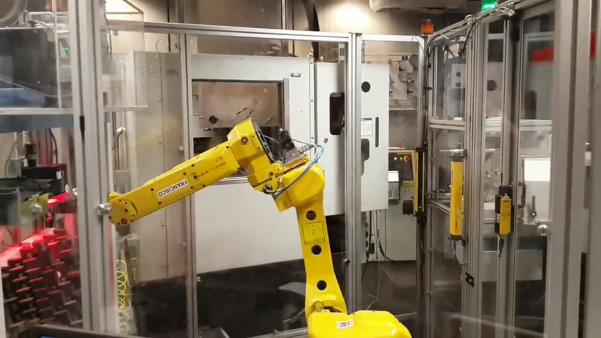 Field footage still showing a FANUC robot inside a Thermo Fisher laboratory automation cell